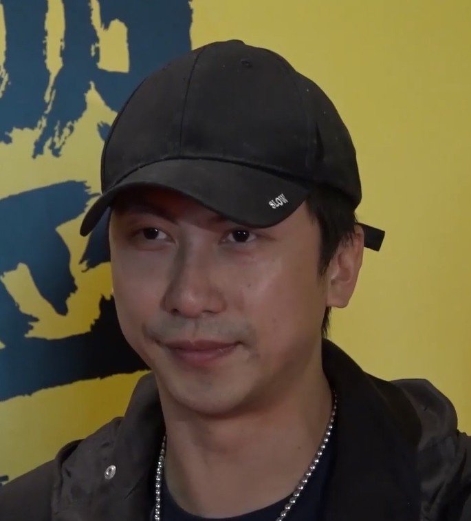 Dennis To wearing a black baseball cap in 2018